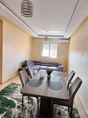 a dining room with a table and chairs at Apartmen rentals with M Z in Oulad Akkou
