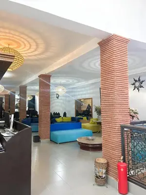 a lobby with blue and yellow furniture in a building at Fekhara CC in Marrakech