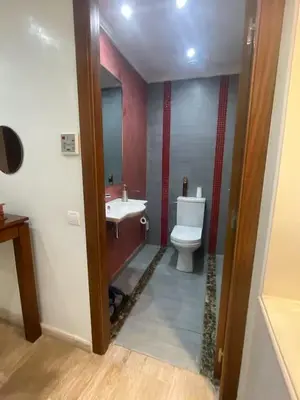 a bathroom with a toilet and a sink and a mirror at Résidence Soltana in Marrakech