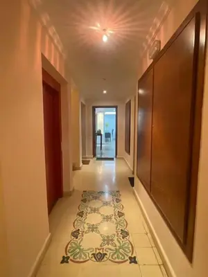 a hallway with a rug on the floor in a building at Résidence Soltana in Marrakech