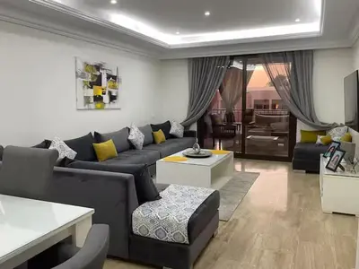 a living room with a couch and a table at Résidence Soltana in Marrakech
