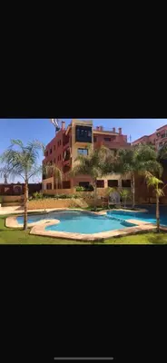 a large swimming pool in front of a building at Résidence Soltana in Marrakech