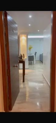 a room with a hallway with a table and a door at Résidence Soltana in Marrakech