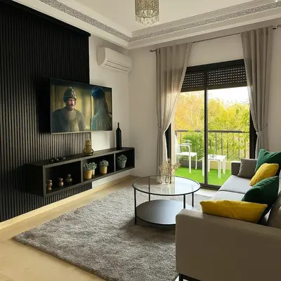 a living room with a couch and a table at Modern apartment with Atlas view in Marrakech