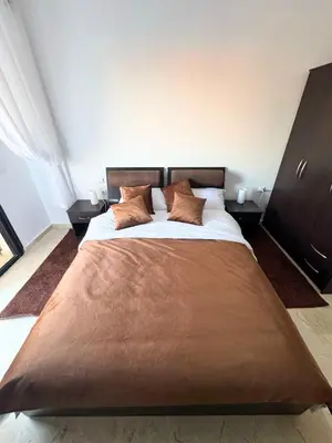 a bedroom with a large bed with two pillows at Modern apartment with Atlas view in Marrakech
