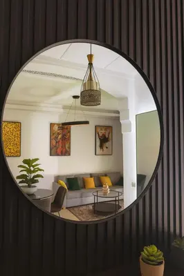 a mirror in a living room with a couch at Modern apartment with Atlas view in Marrakech