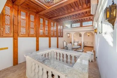a staircase in a room with a wooden ceiling at Riad Lalla Rachida in Medina Heart Of Marrakech B&B in Marrakech