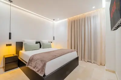 a bedroom with a white bed and a large window at Stylish Downtown Apartment Optical Fiber Included in Marrakech