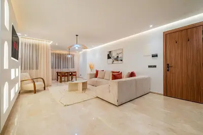 a living room with a couch and a table at Stylish Downtown Apartment Optical Fiber Included in Marrakech