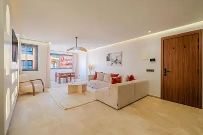 a living room with a couch and a table at Stylish Downtown Apartment Optical Fiber Included in Marrakech