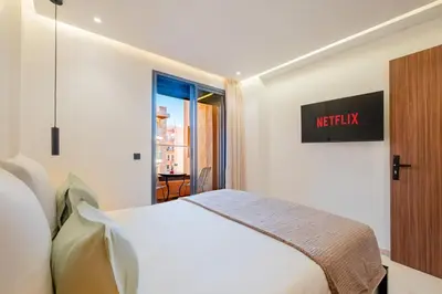 a hotel room with a bed and a window at Stylish Downtown Apartment Optical Fiber Included in Marrakech
