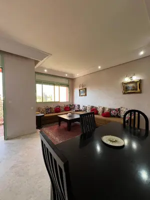 a living room with a table and a couch at Marakech Giliz Atlas in Marrakech