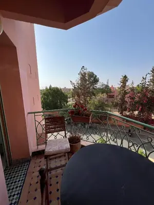a balcony with a table and chairs and a view at Marakech Giliz Atlas in Marrakech