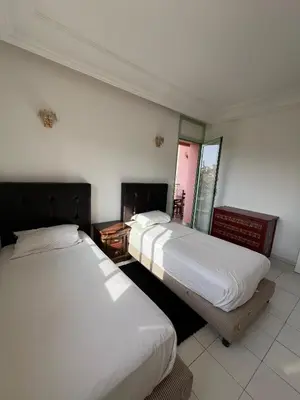 two beds in a hotel room with two beds sidx sidx sidx at Marakech Giliz Atlas in Marrakech