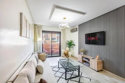 a living room with a couch and a tv at Modern Gueliz, Hivernage City Centre 2 Bedroom Apartment in Marrakech
