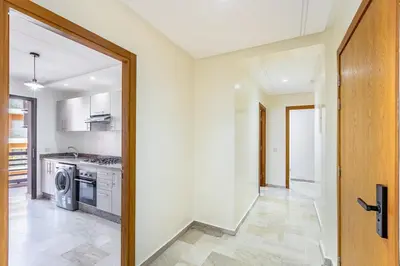 a kitchen with a washer and dryer and a door at Modern Gueliz, Hivernage City Centre 2 Bedroom Apartment in Marrakech