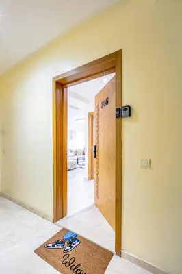 an open door with a welcome mat in a hallway at Modern Gueliz, Hivernage City Centre 2 Bedroom Apartment in Marrakech