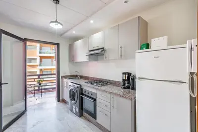 a kitchen with a white refrigerator and a dishwasher at Modern Gueliz, Hivernage City Centre 2 Bedroom Apartment in Marrakech
