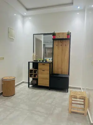 a room with a vanity with a mirror and a stool at Sweet home in Marrakech