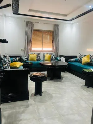 a living room with couches and tables in a room at Sweet home in Marrakech