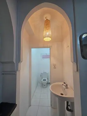 a bathroom with a sink and a toilet and a chandelier at Marrakech gueliz in Marrakech