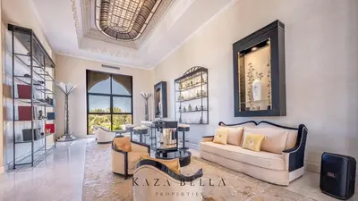 a living room with a couch and a table at KAZA BELLA - Palais Les Orchidées in Marrakech