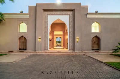 an entry to a building with a large doorway at KAZA BELLA - Palais Les Orchidées in Marrakech