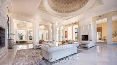 a large living room with white furniture and a fireplace at KAZA BELLA - Palais Les Orchidées in Marrakech