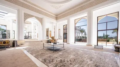 a large room with large windows and a table at KAZA BELLA - Palais Les Orchidées in Marrakech