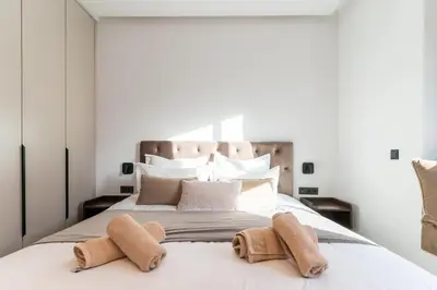 a bedroom with a large white bed with towels on it at Elegant Villa Free Breakfast Heated Pool Spa in Marrakech