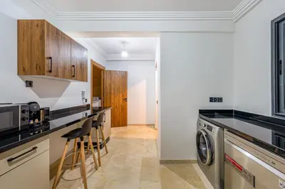 a kitchen with a washer and dryer at Grand duplex 4 ch - Piscine - Marrakech in Marrakech