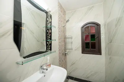 a bathroom with a sink and a mirror at Riad Pearl Marrakech 4 Rooms Jacuzzi Terrace shared Pool in Marrakech
