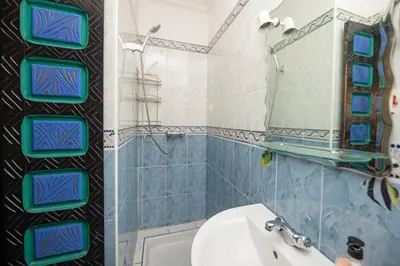 a bathroom with a sink and a toilet and a mirror at Riad Pearl Marrakech 4 Rooms Jacuzzi Terrace shared Pool in Marrakech