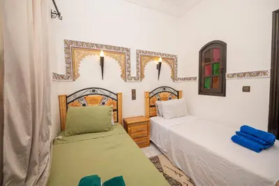 a bedroom with two beds and a window at Riad Pearl Marrakech 4 Rooms Jacuzzi Terrace shared Pool in Marrakech