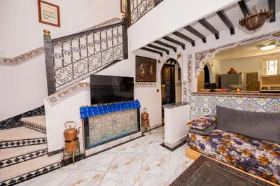 a living room with a couch and a fireplace at Riad Pearl Marrakech 4 Rooms Jacuzzi Terrace shared Pool in Marrakech