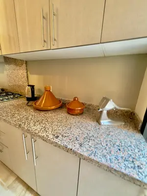 a kitchen counter with two copper utensils on it at Charmant Duplex 2BR - quartier Hivernage - Piscine in Marrakech