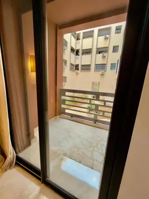 a view of a balcony from a window at Charmant Duplex 2BR - quartier Hivernage - Piscine in Marrakech