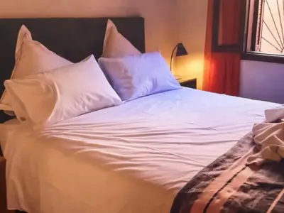 a large white bed with white pillows on it at Urban Escape in Marrakesh in Marrakech