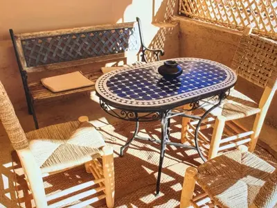 a blue and white table and chairs on a balcony at Urban Escape in Marrakesh in Marrakech