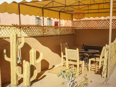 a room with a table and chairs and a cactus at Urban Escape in Marrakesh in Marrakech