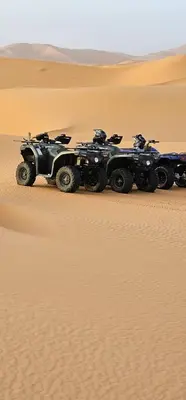 a group of four atvs in the desert at Menara Airport Transfers in Marrakech