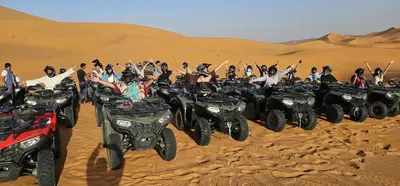 a group of people on atvs in the desert at Menara Airport Transfers in Marrakech