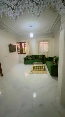 a living room with a green couch and a ceiling at Chic & Cozy Apartment in Marrakech
