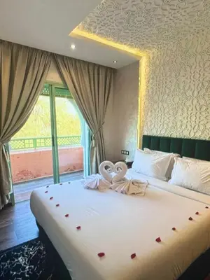 a bedroom with a large bed with a large window at Stylish Retreat in Marrakech
