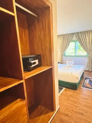 a room with a bedroom with a bed and a book shelf at Stylish Retreat in Marrakech