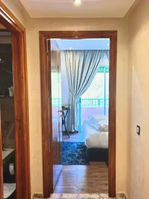 a room with a door leading to a bedroom with a bed at Stylish Retreat in Marrakech