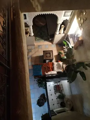 an overhead view of a living room with a fireplace at Dar tranquille in Marrakech