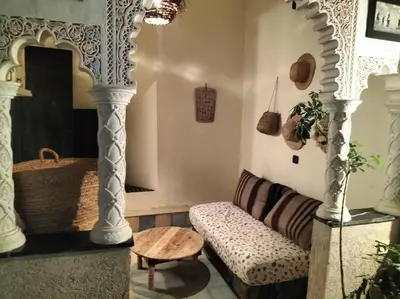 a living room with a couch and a table at Dar tranquille in Marrakech