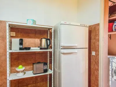a kitchen with a white refrigerator and shelves at Timeless Hideaway in Marrakech