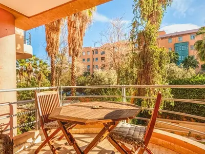 a patio with a table and chairs on a balcony at Timeless Hideaway in Marrakech